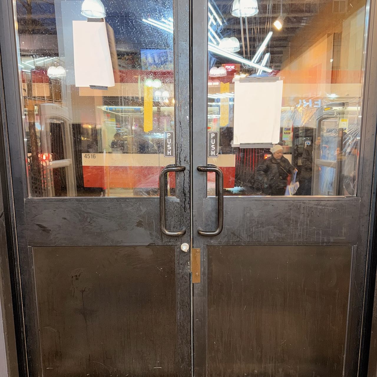 Commercial storefront double doors secured after forced-entry repair
