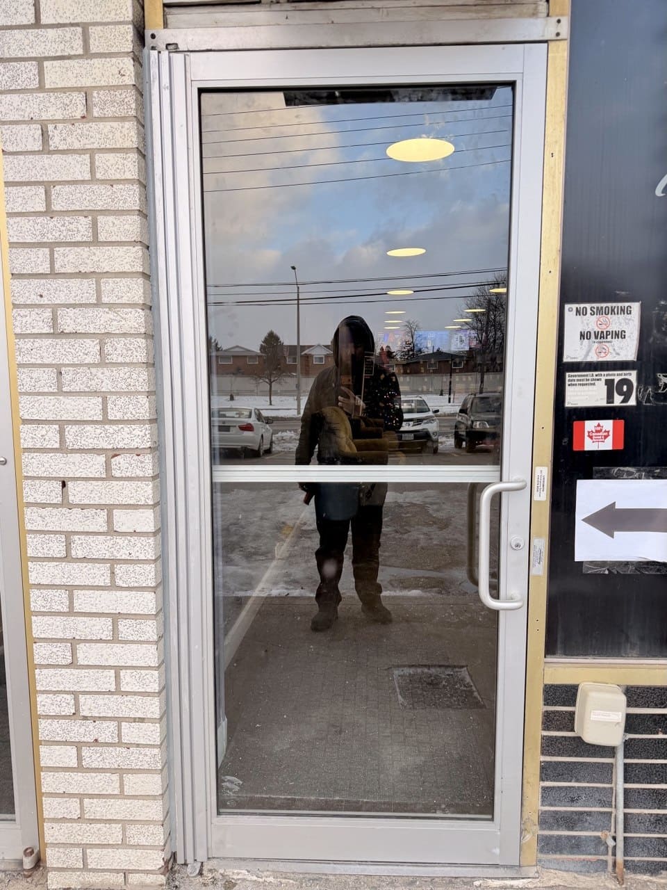 Newly installed commercial aluminum replacement doors after emergency board-up and measuring