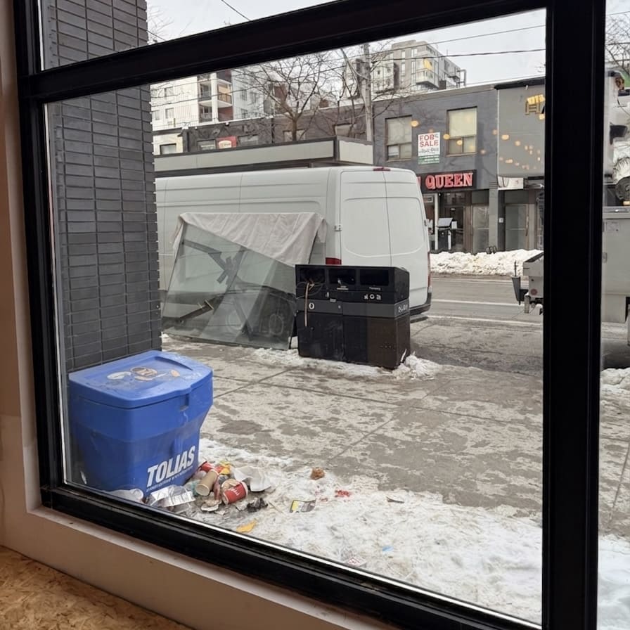 Commercial glass installed from inside with broken glass removed for disposal
