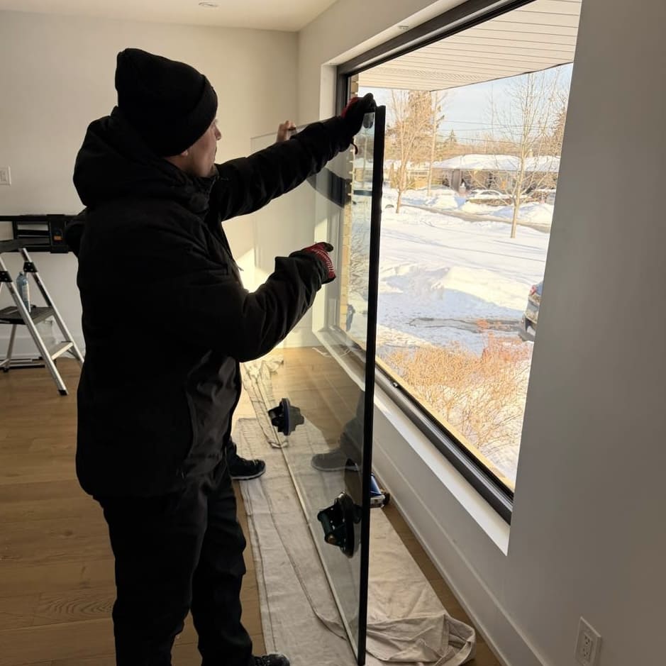 Technician preparing new residential glass for installation