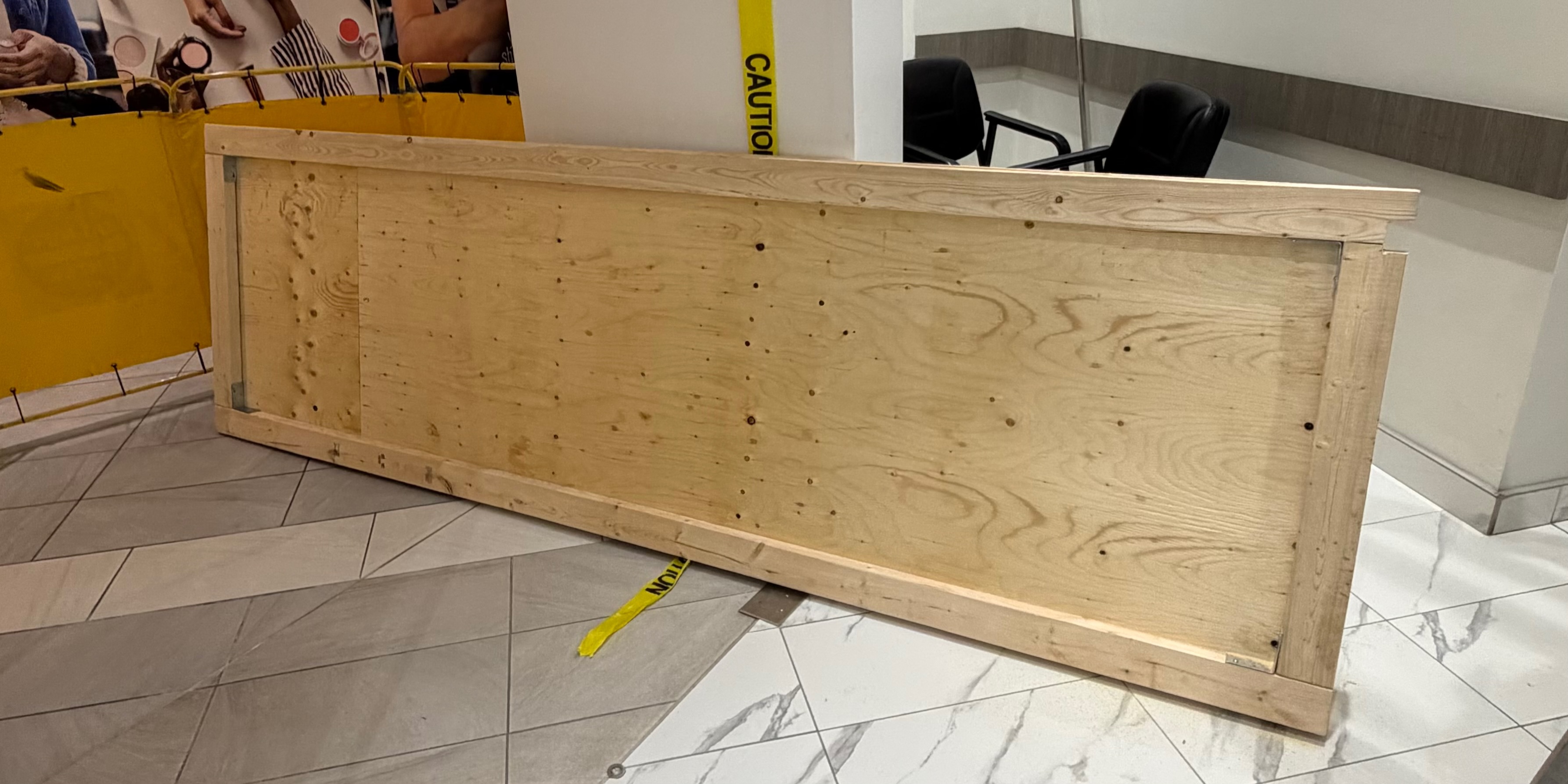 Custom plywood board-up panel prepared for a storefront opening