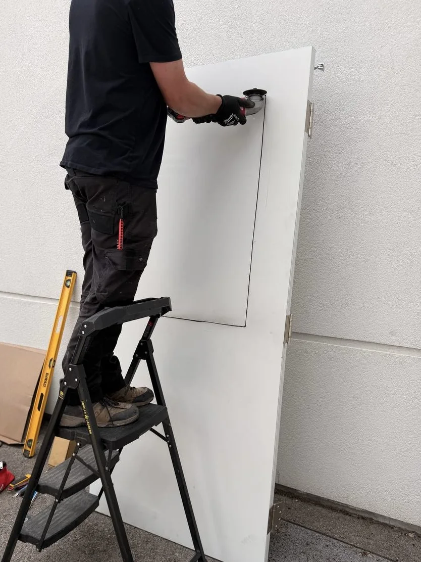 Steel door being cut and prepared for a new GPW vision lite opening