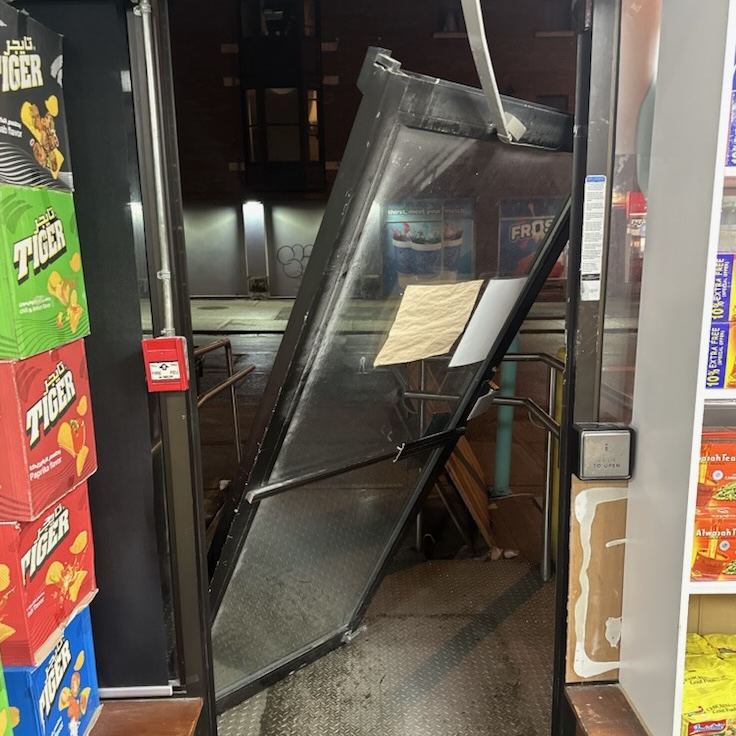 Commercial entrance door displaced from its frame before emergency repair