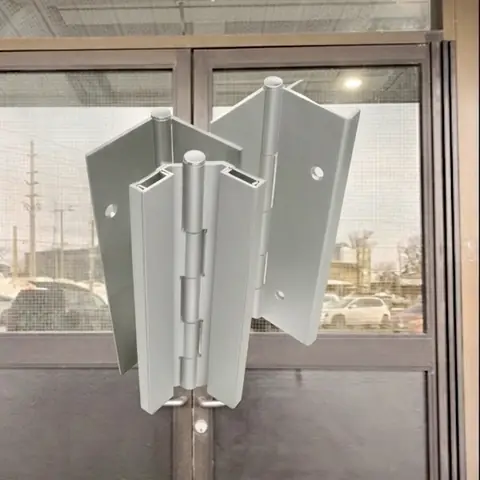 Full-length continuous hinge installed on a commercial entrance door