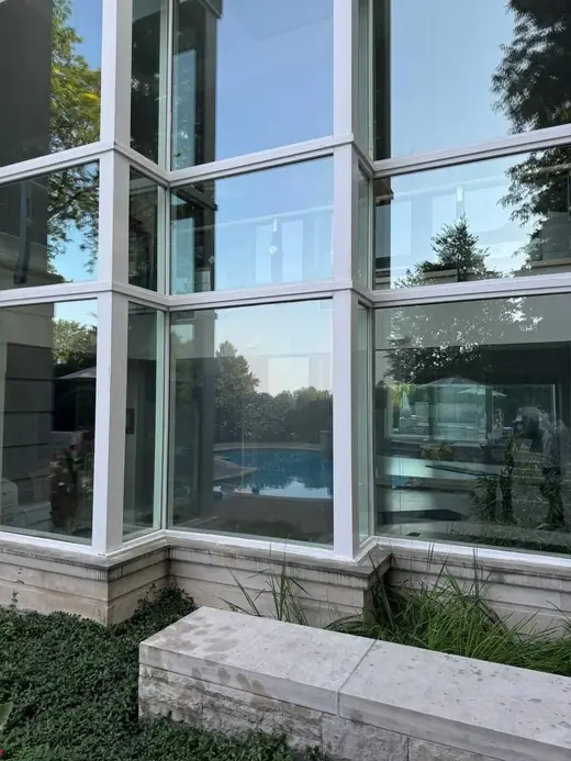 Recaulked panoramic corner window in Oakville with fresh exterior sealant.