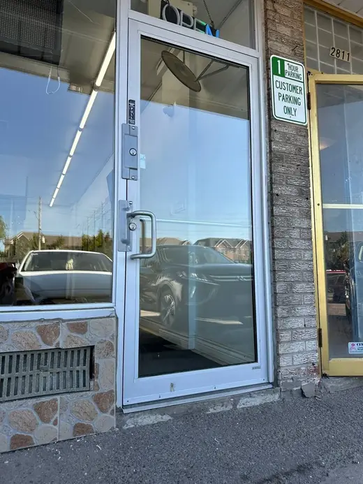 New full-height glass panel installed in an aluminum business entrance in Vaughan