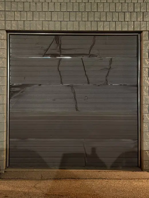 Commercial overhead garage door in Oshawa restored to a closable position after emergency stabilization