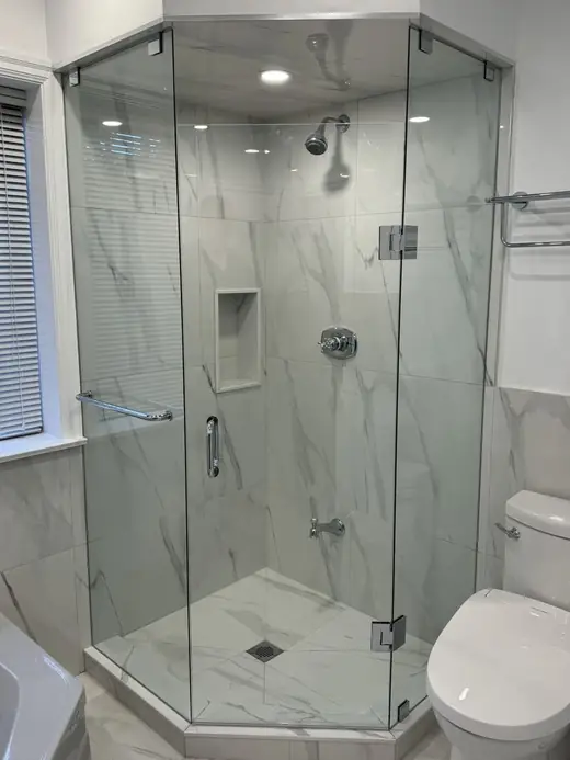 Completed neo-angle frameless shower enclosure with silicone-sealed glass in Richmond Hill