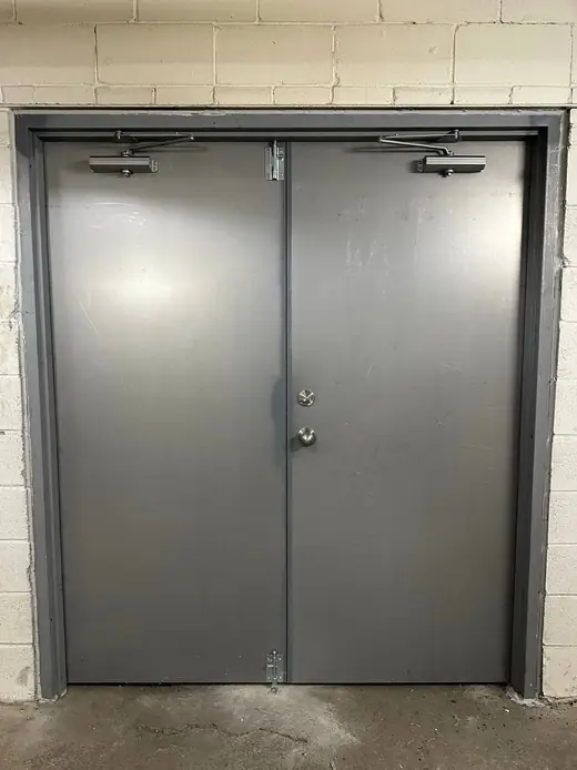Commercial double steel doors installed in Clarington with two surface door closers