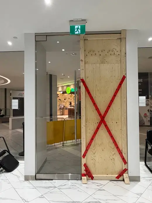 Emergency board-up installed over a broken office glass partition in North York