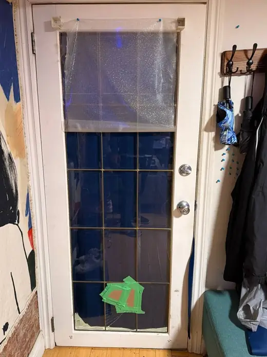 Broken interior door glass panel in an Etobicoke hallway before replacement