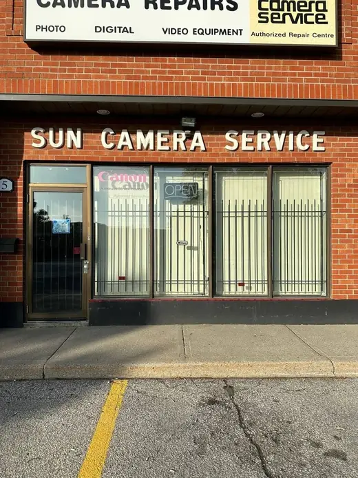 Sun Camera storefront in North York before glass door and aluminum framing replacement