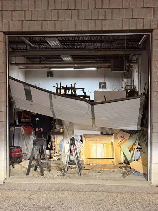 Commercial garage door in Oshawa after impact damage and before emergency repair