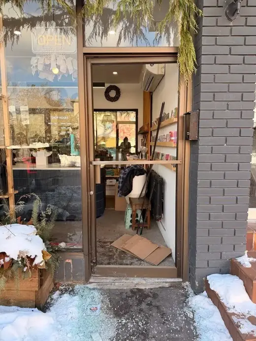 Midtown Toronto flower shop door with damaged glass before same-day replacement