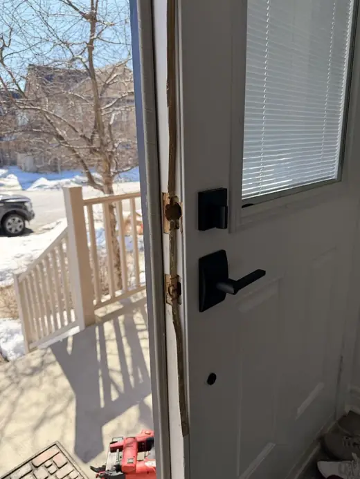 Front door in Milton after break-in damage to the astragal and before emergency repair