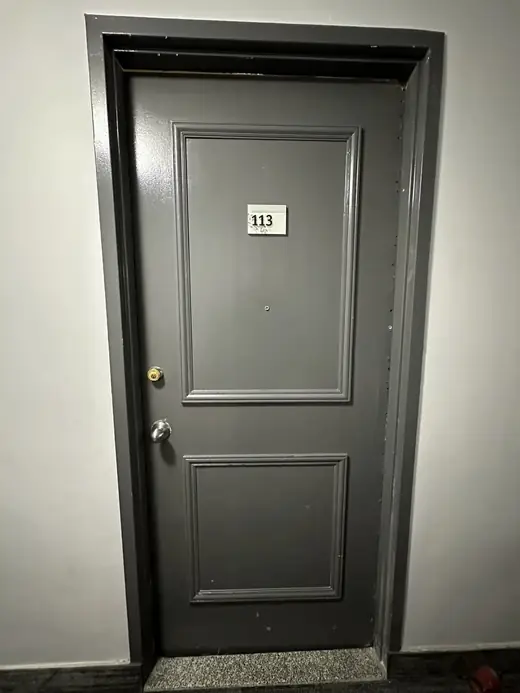 Old apartment entry door in Ajax before replacement
