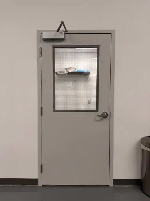 Finished hollow metal door with GPW wired glass and closer in Richmond Hill