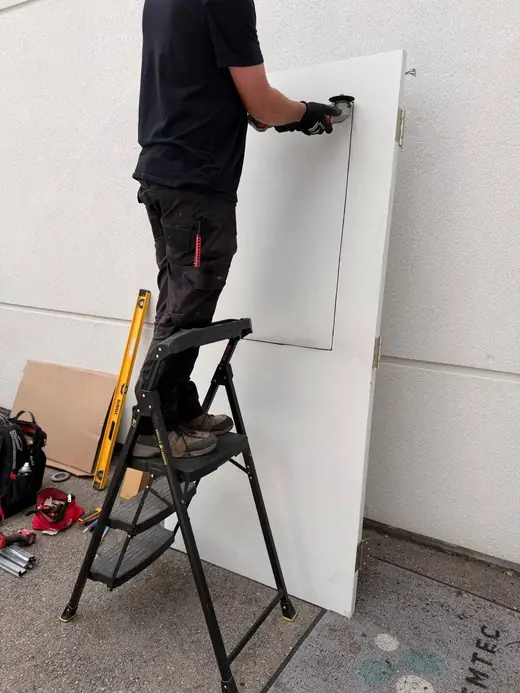 Metal door being prepared for GPW wire glass vision lite in Richmond Hill