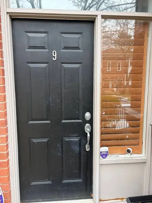 Old black front entry door in Newmarket before replacement