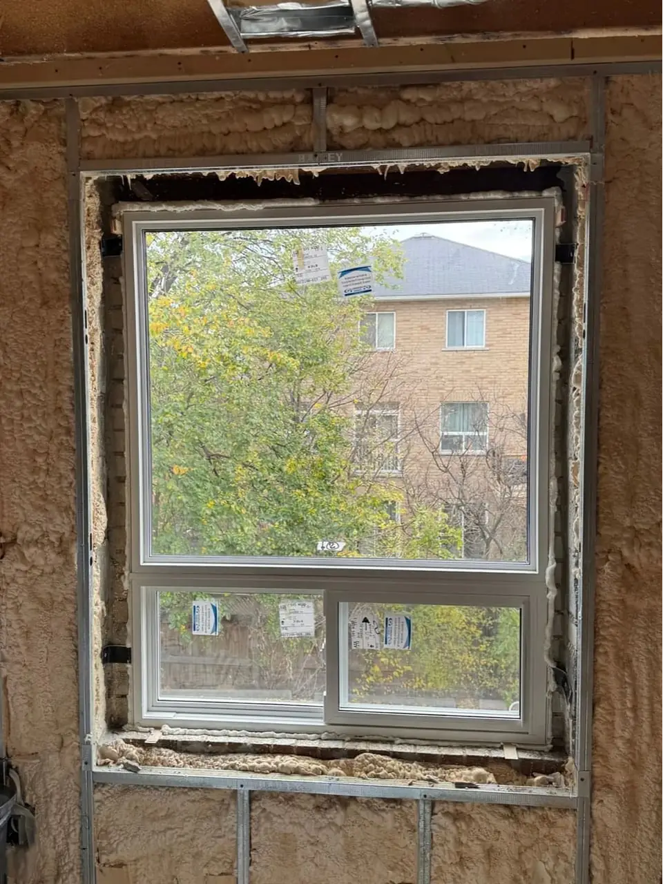 Replacement window installed in Mississauga, with perimeter foam visible before surrounding wall finishes.