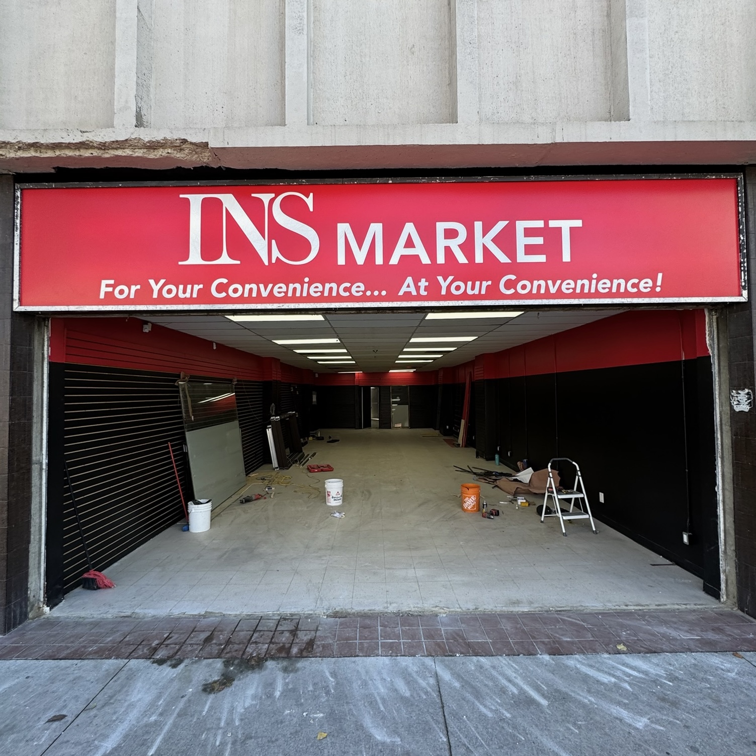 Existing retail storefront opening before aluminum storefront entrance replacement