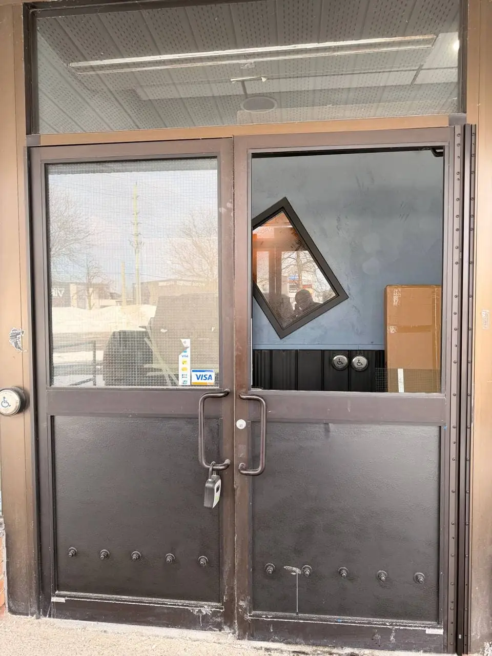 Pickering commercial entrance with damaged GPW glass before hinge service and glass replacement