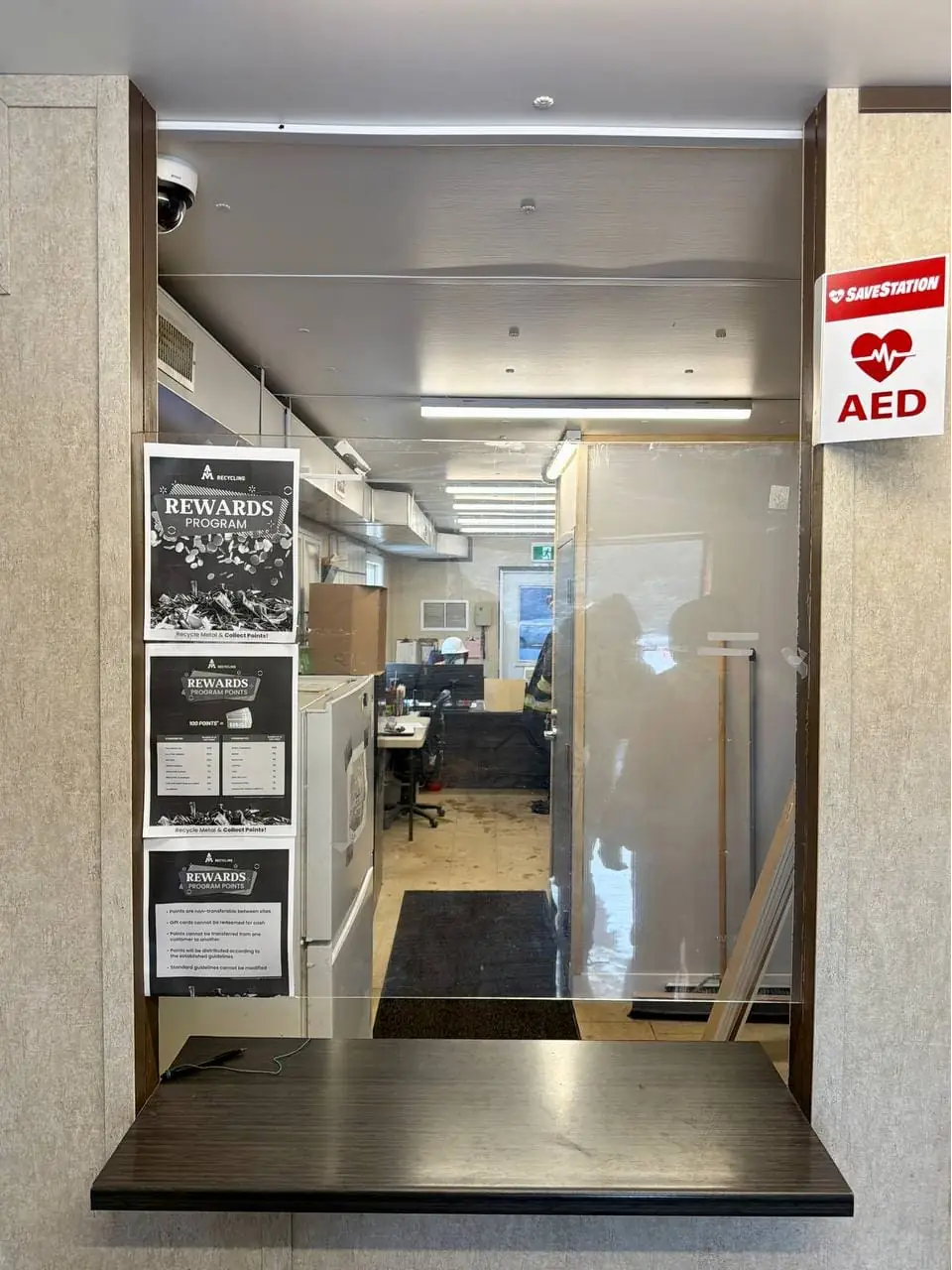 Secure service window in Cedar Valley before armored glass replacement.