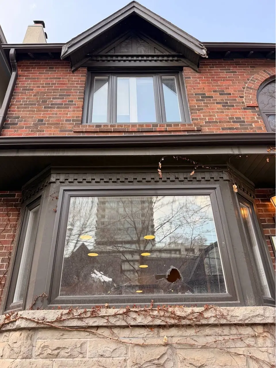 Broken front bay window glass on a Whitby home before replacement