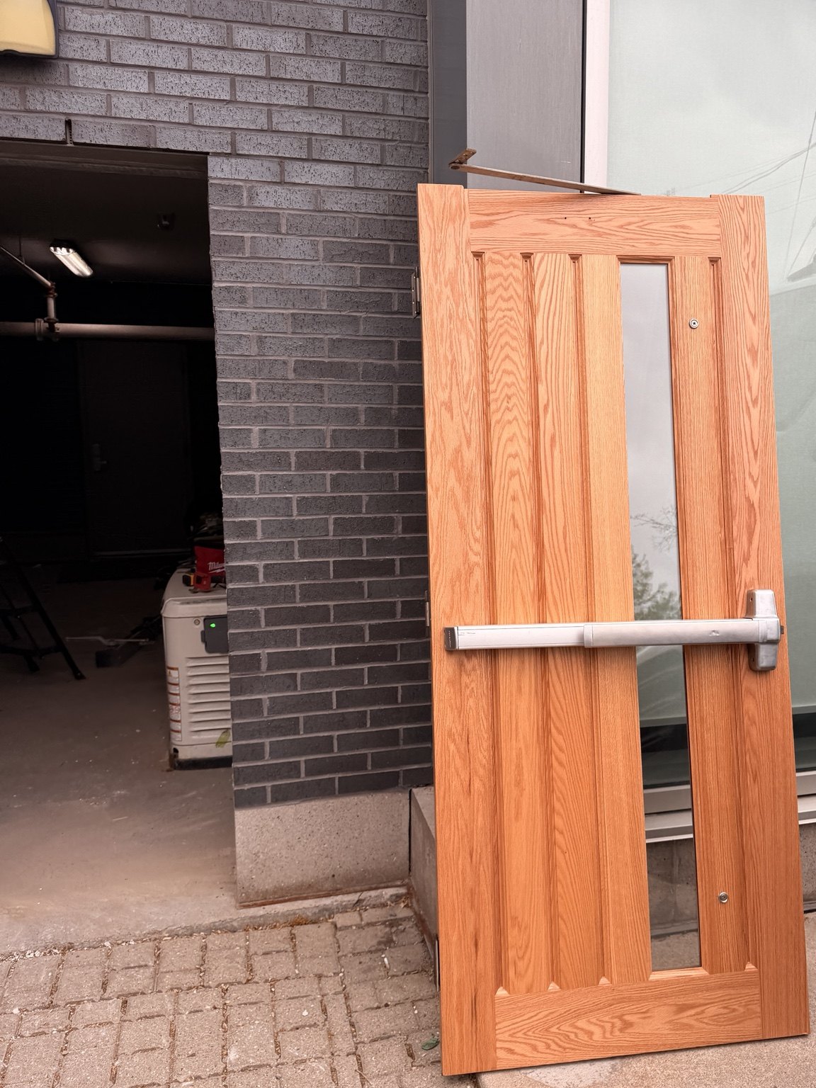 New wood grain commercial door prepared for installation