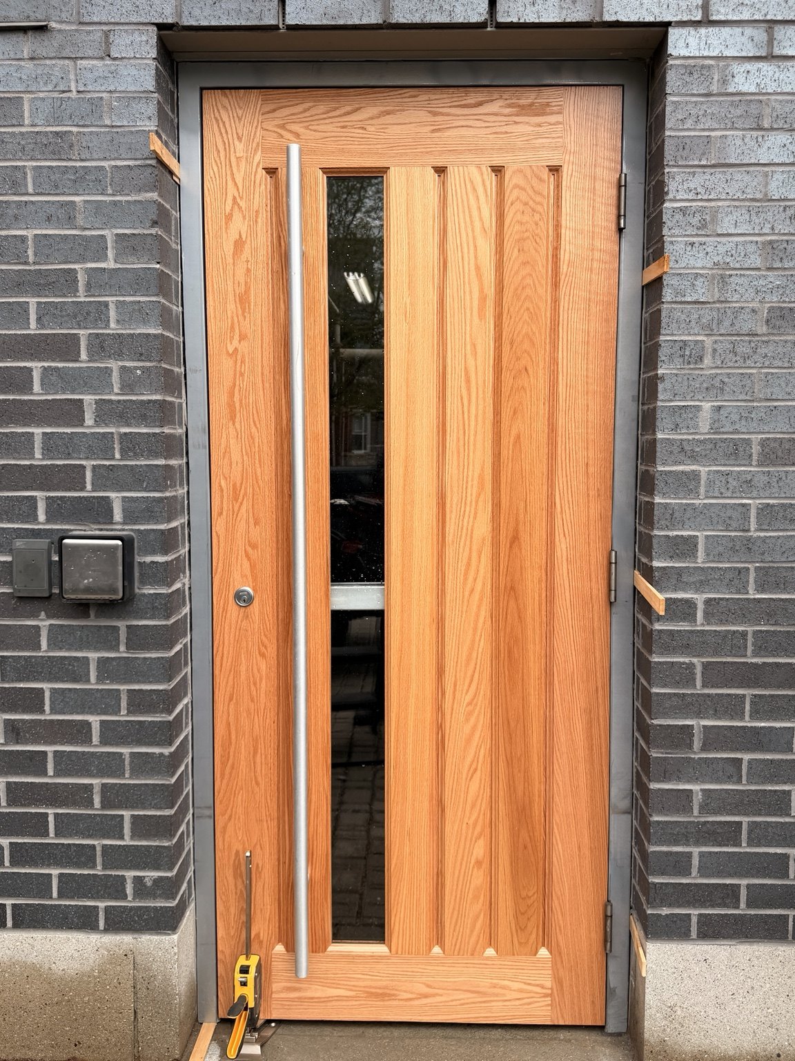 New commercial door installed and being aligned in the opening