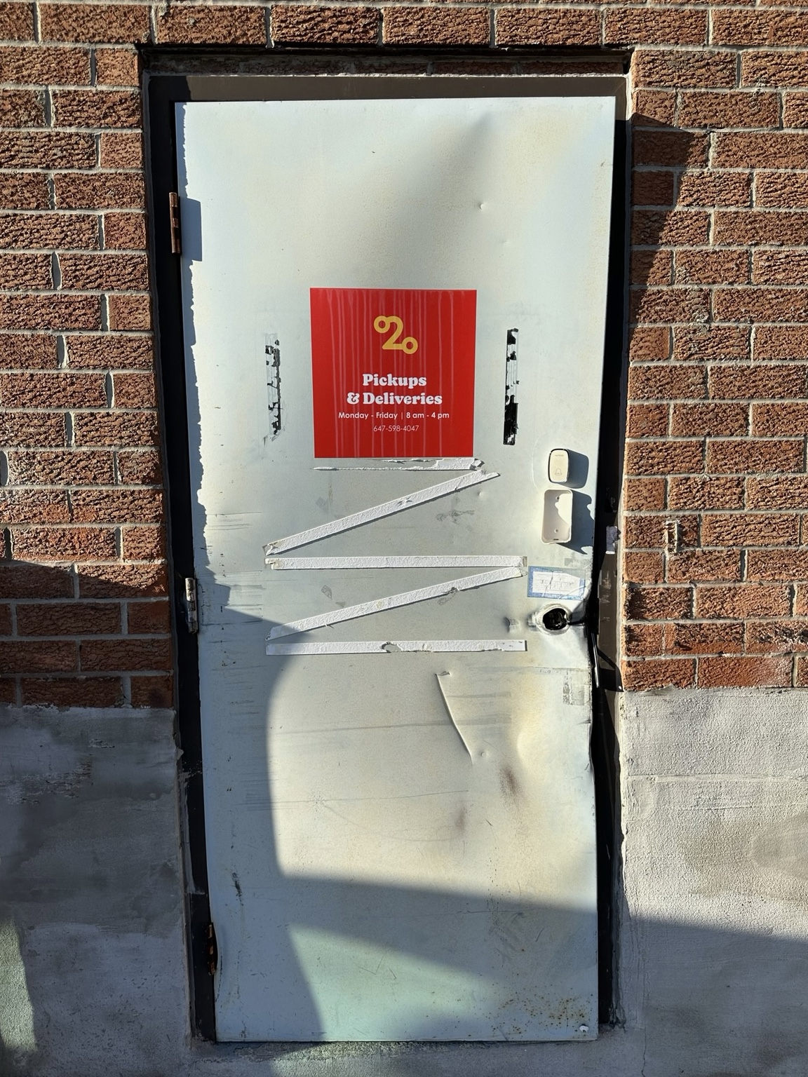 Damaged exterior commercial steel door before emergency replacement