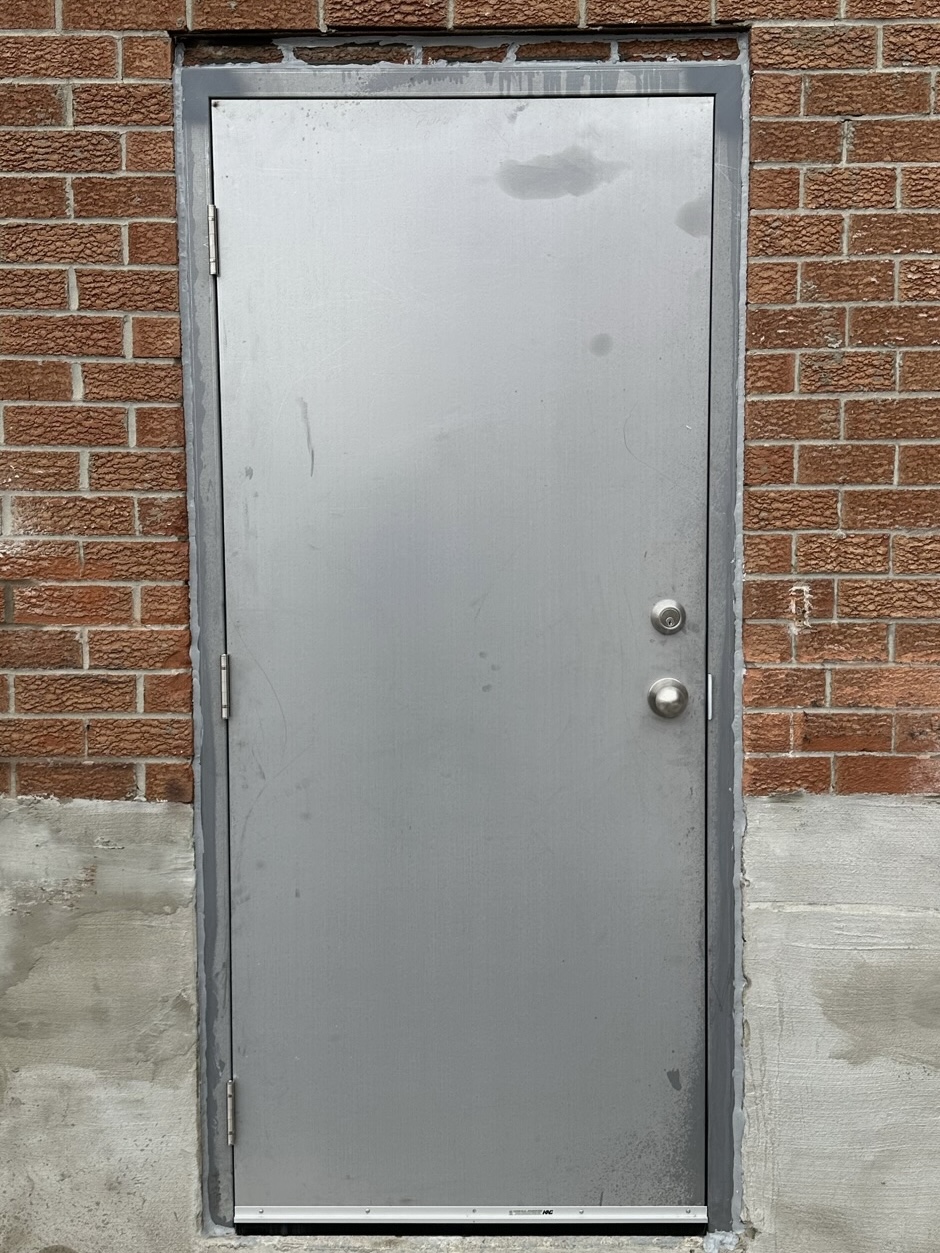Completed emergency steel door and frame replacement at exterior commercial entrance