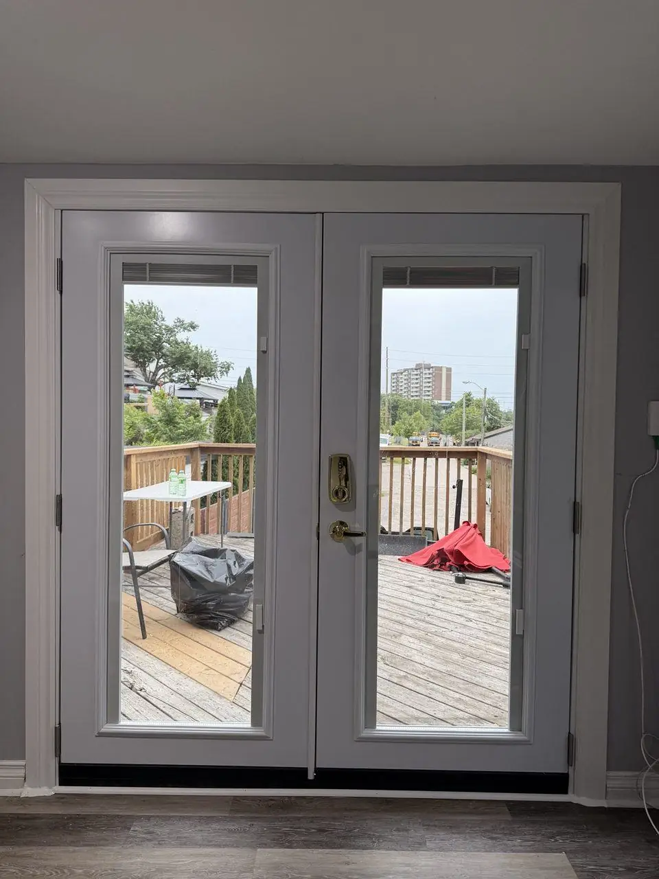 New French patio doors installed from inside with built-in blinds between glass panes