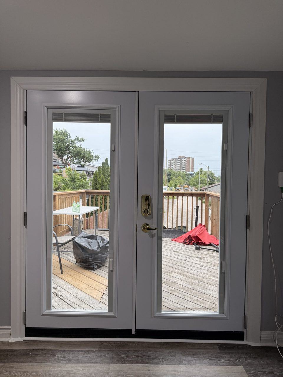 New French patio doors installed from inside with built-in blinds between glass panes
