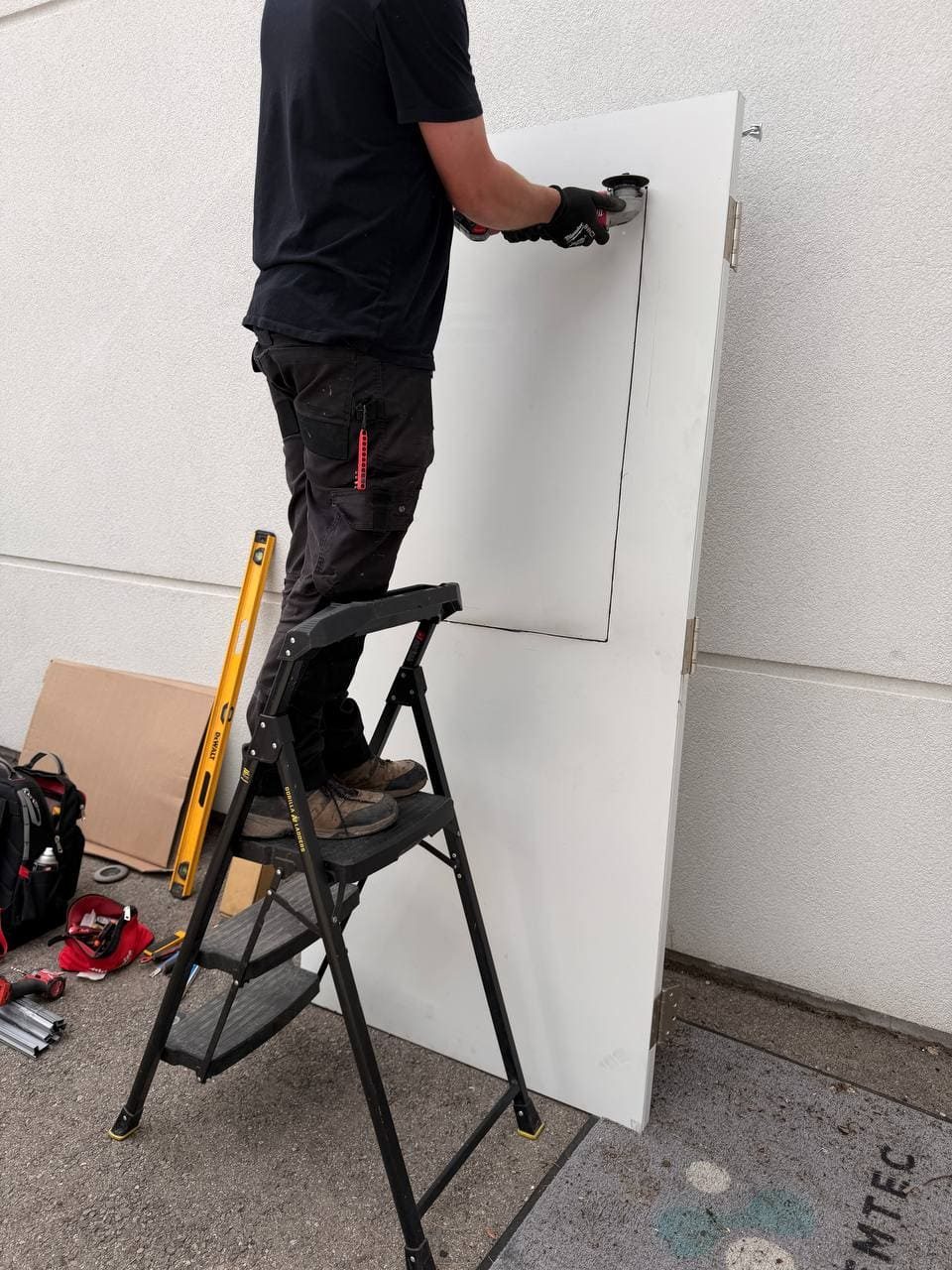 Metal door being prepared for GPW wire glass vision lite in Richmond Hill