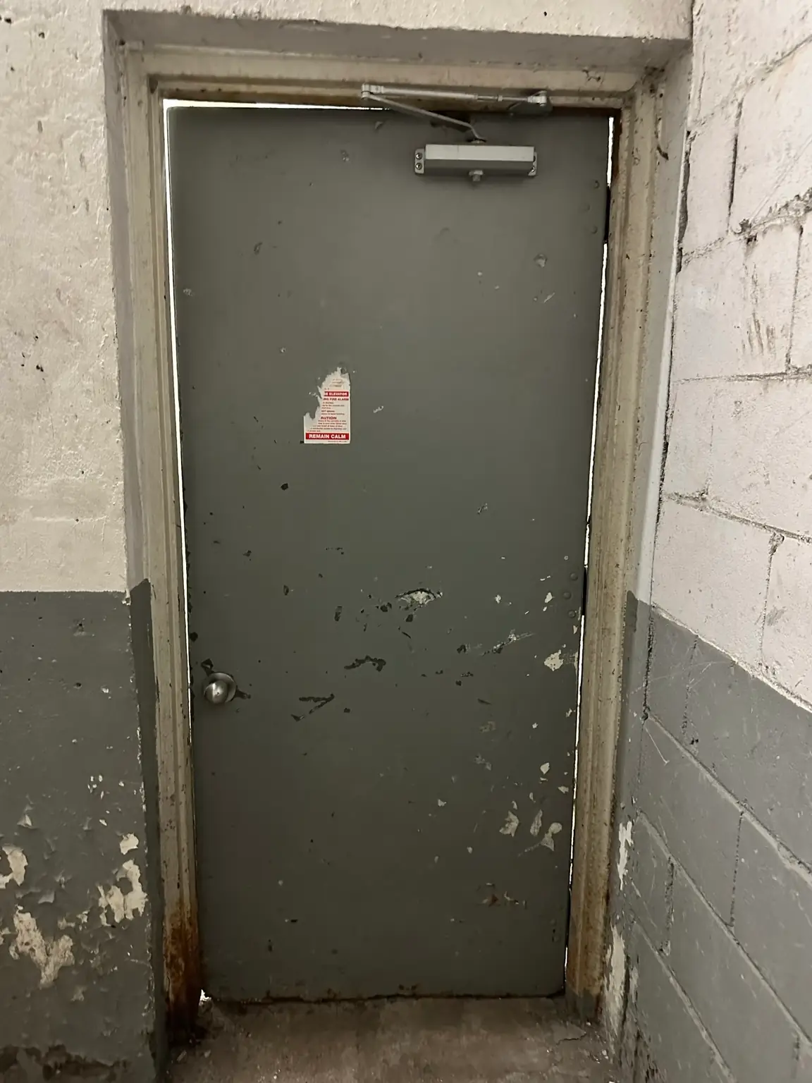 Worn commercial hollow metal door and frame before replacement