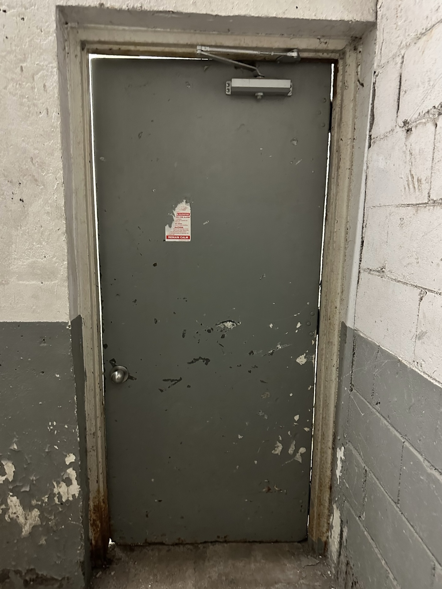 Worn commercial hollow metal door and frame before replacement