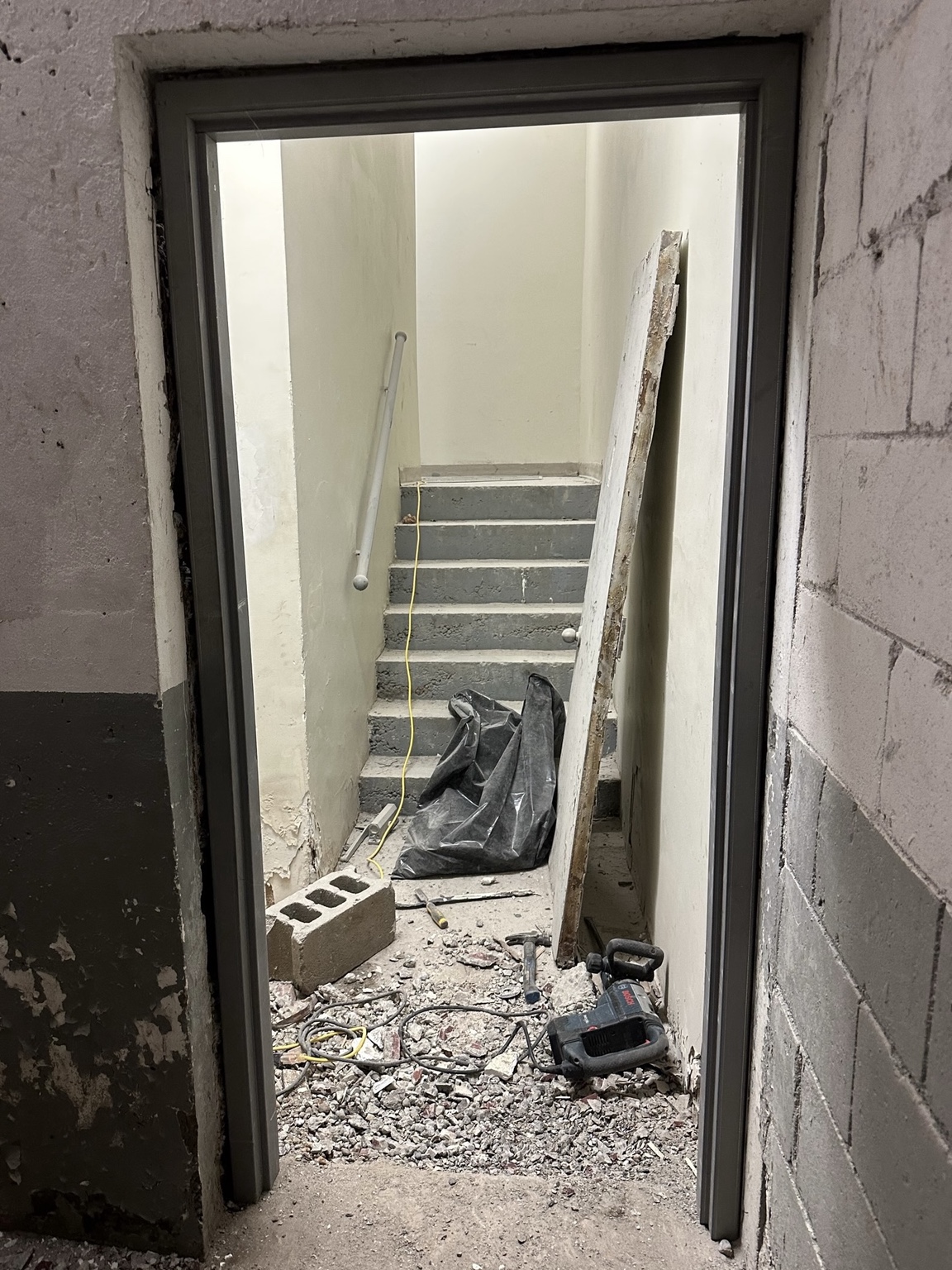 New hollow metal door frame installed and levelled in stairwell opening