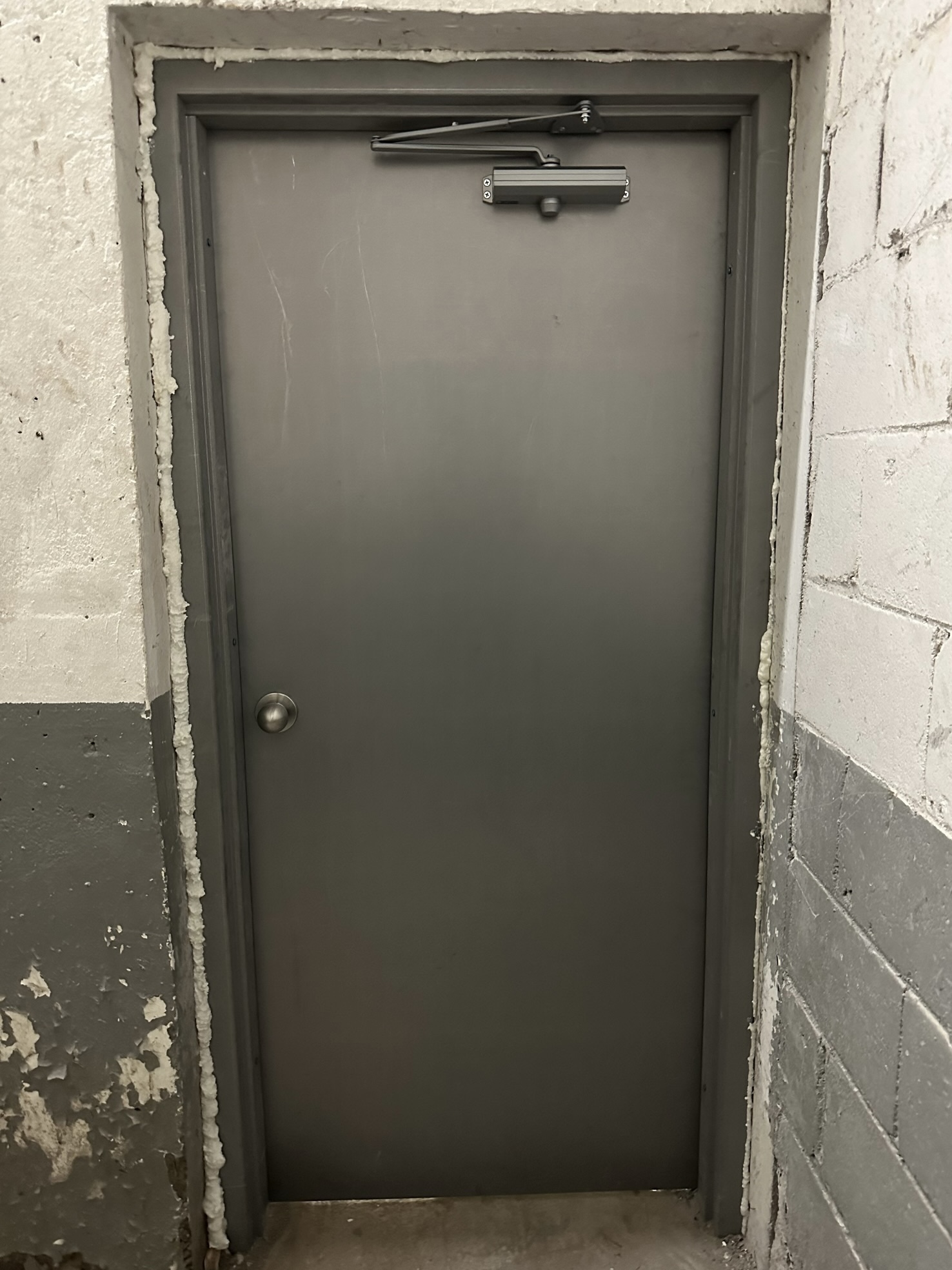 Completed hollow metal door and frame replacement with new door closer