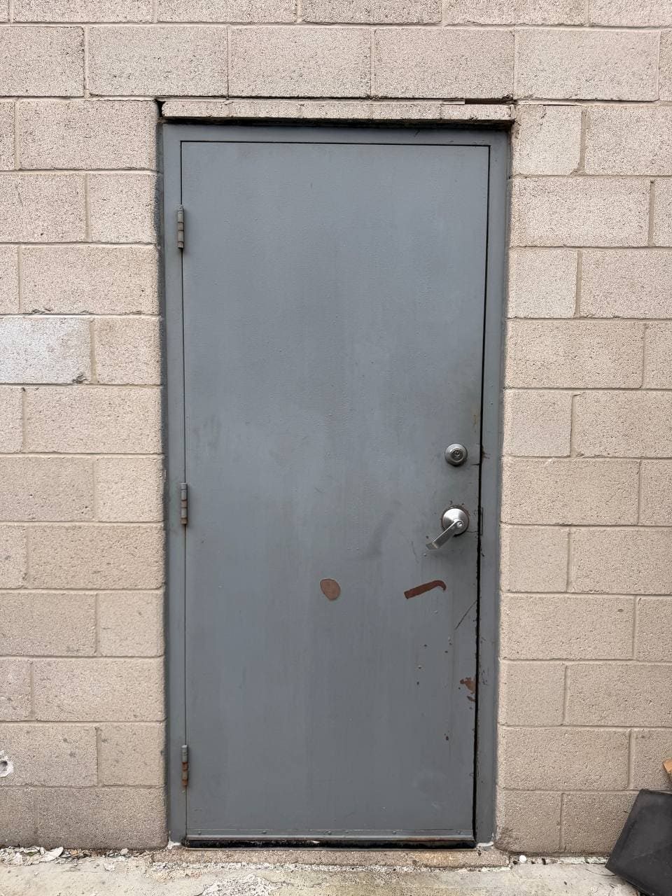 Old metal rear service door in Pickering before replacement