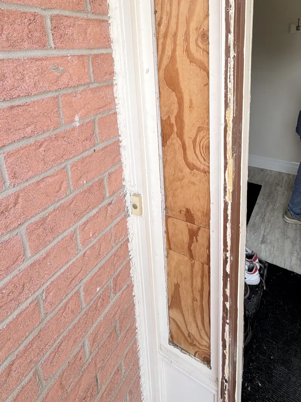 Entry door sidelight opening temporarily covered before glass replacement in Mississauga