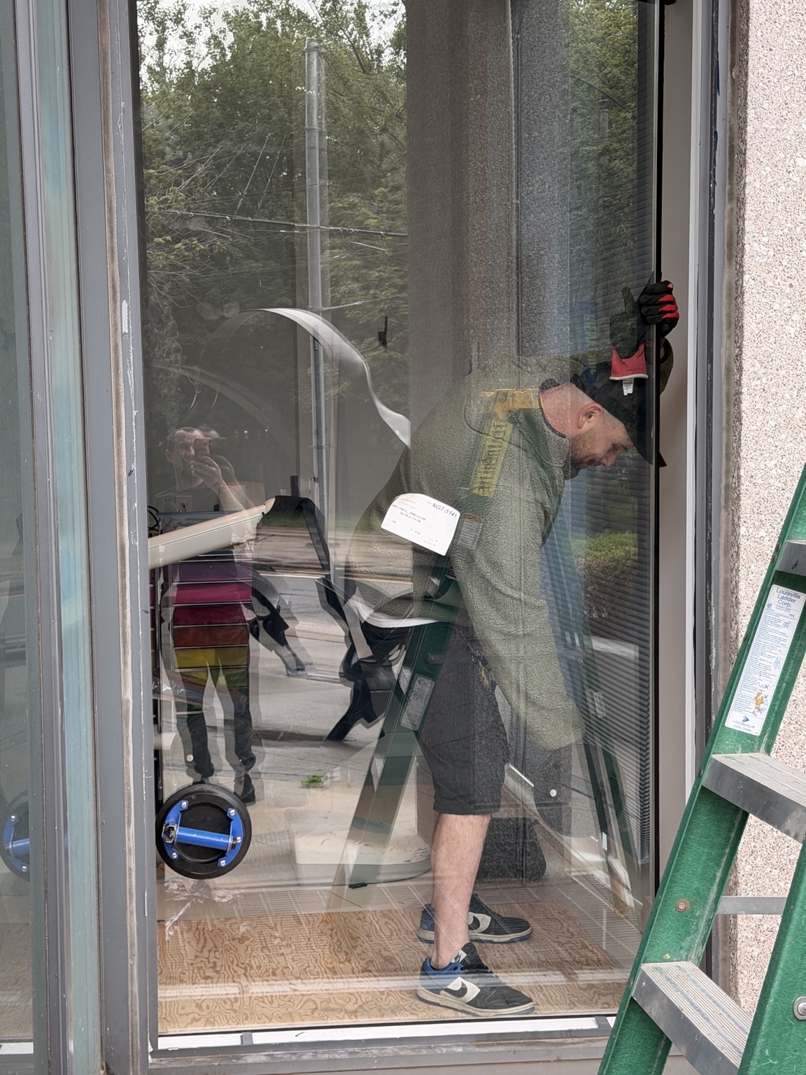 New storefront glass unit being installed into existing commercial frame