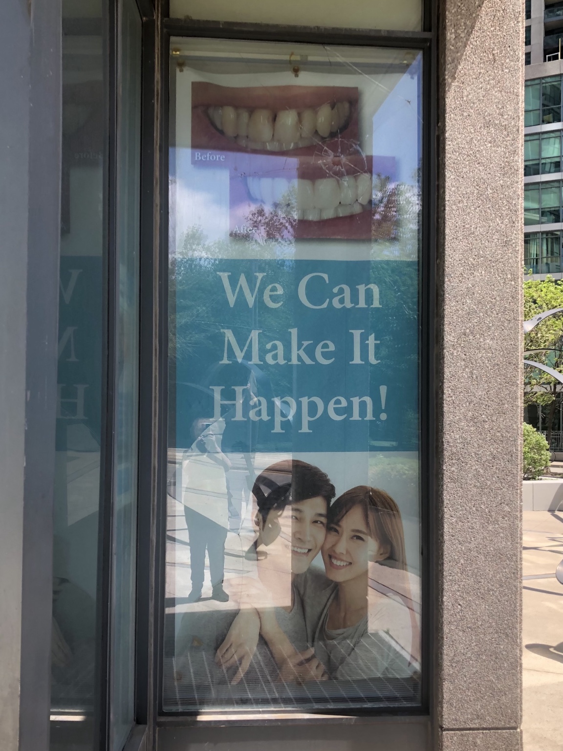 Advertising banner restored on new storefront glass after replacement