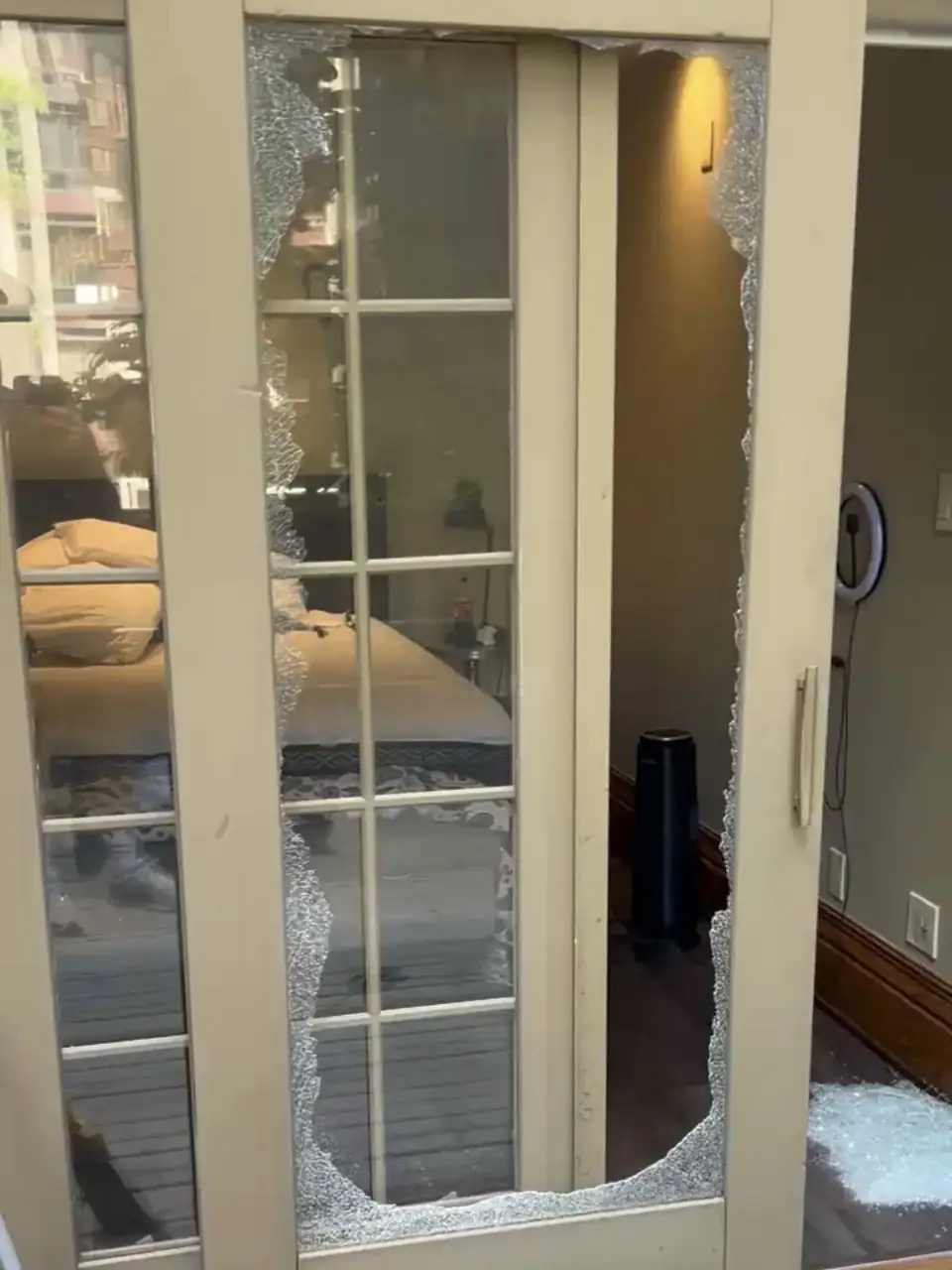 Shattered sliding patio door glass with grille before repair in Yorkville Toronto