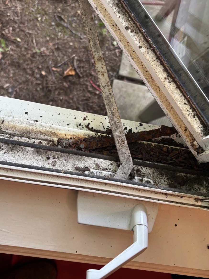 Rusted casement window crank operator before replacement near Humberwood Park, Toronto